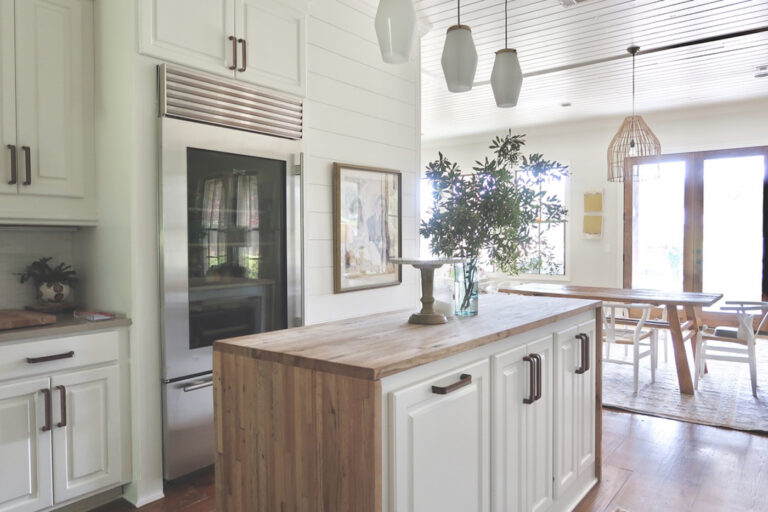 Kitchen Renovation // BEFORE AND AFTER // New quartz countertops, wooden hardware, reclaimed butcher block waterfall island, jura gray quartz on surround